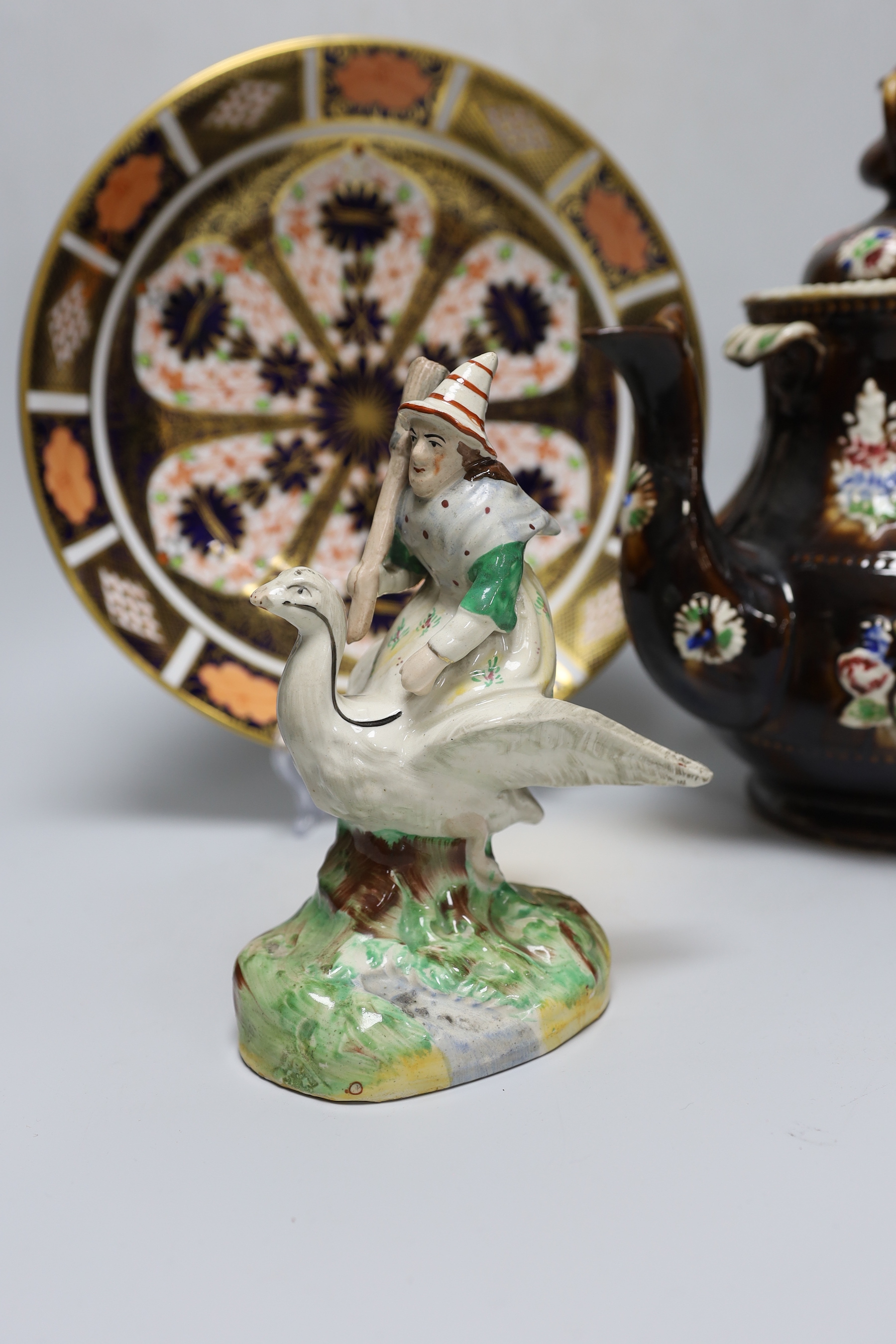 A Measham Bargeware teapot, a Derby Imari 1128 dish and an unusual Victorian Staffordshire group of a witch riding a goose, tallest 27cm